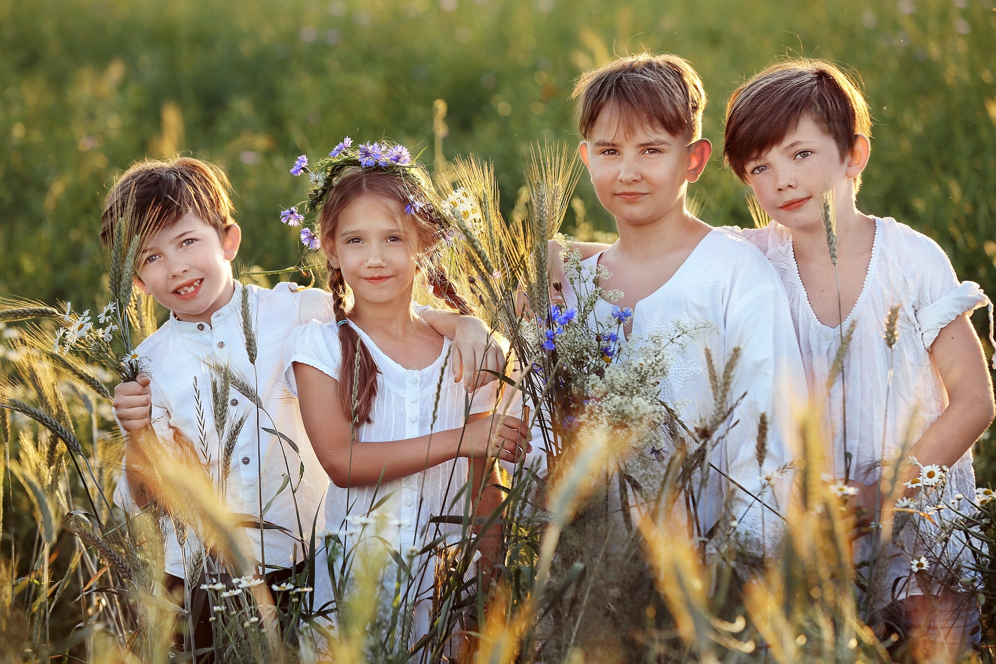 children in white clothes in the field